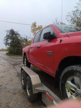 Sell My Scrap Car | Red RAM 1500 on Trailer for Junk Car Removal